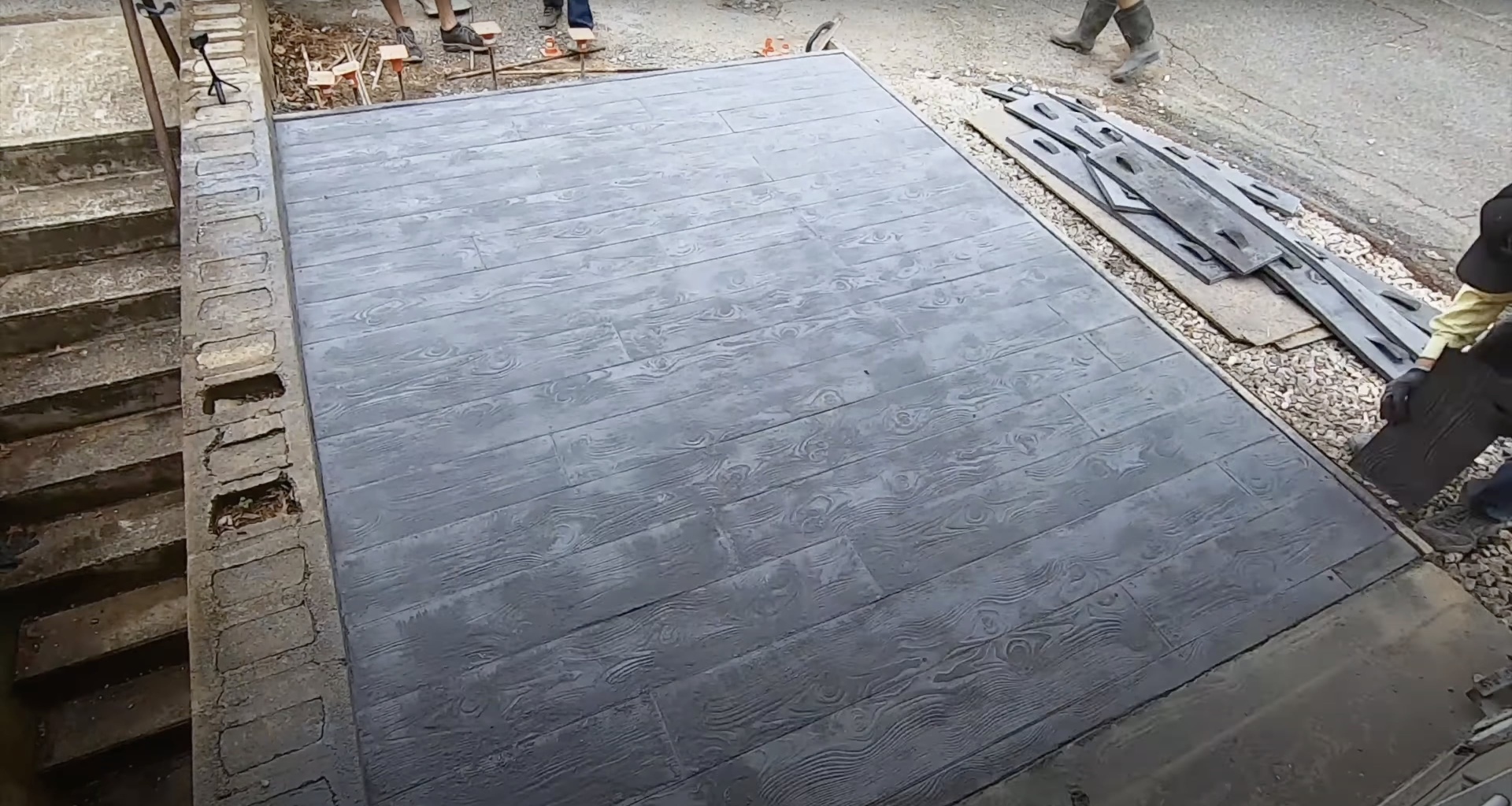 Commercial concrete installation showing scale and professional equipment used for large projects Large commercial concrete slab with professional finishing and construction materials visible