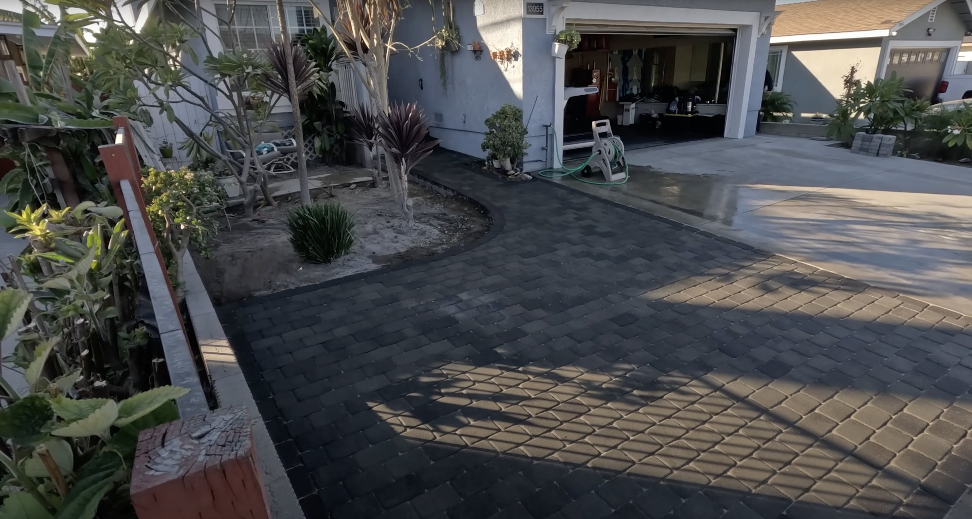 Decorative stamped concrete driveway with interlocking paver pattern