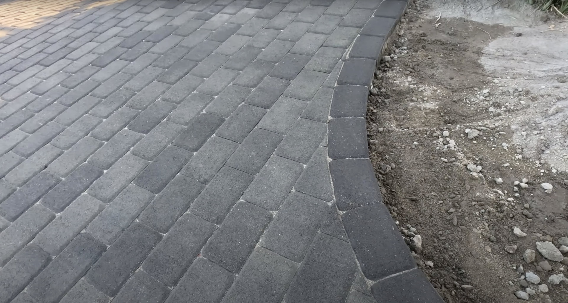 Professional paver installation showing quality craftsmanship and attention to detail Beautiful interlocking concrete pavers being installed in herringbone pattern