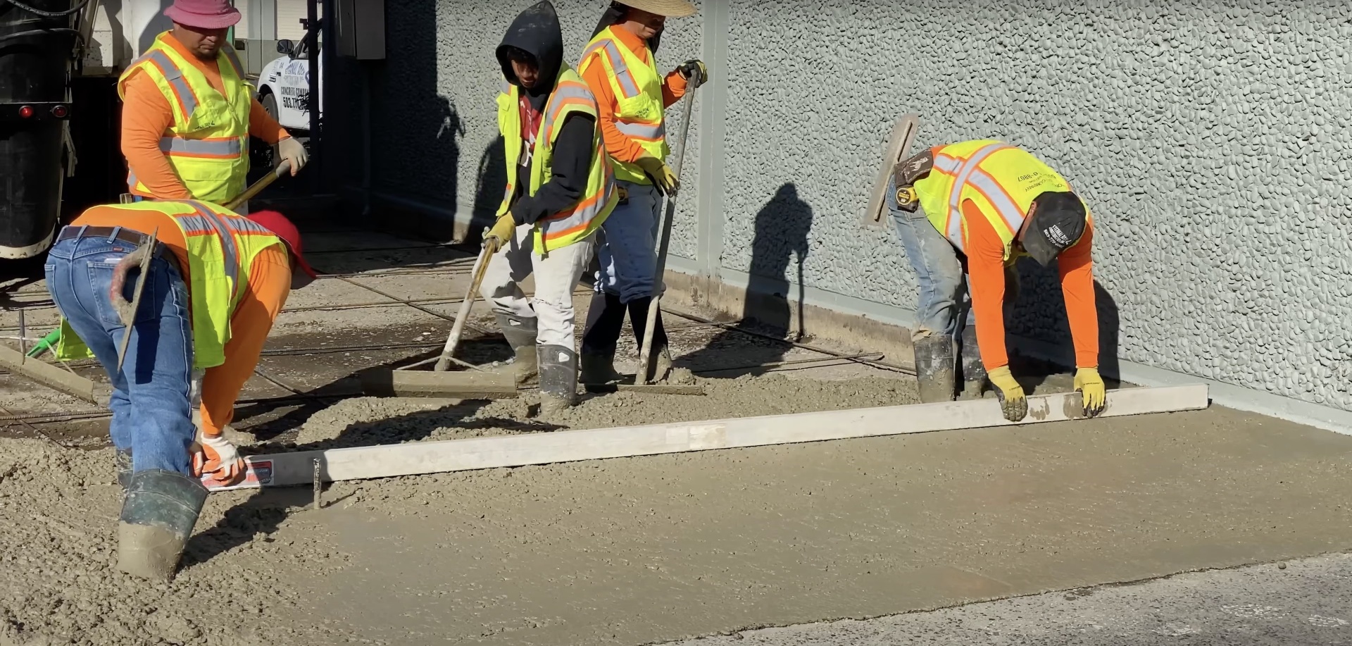 Professional concrete sidewalk installation crew working on walkway in Evans, CO